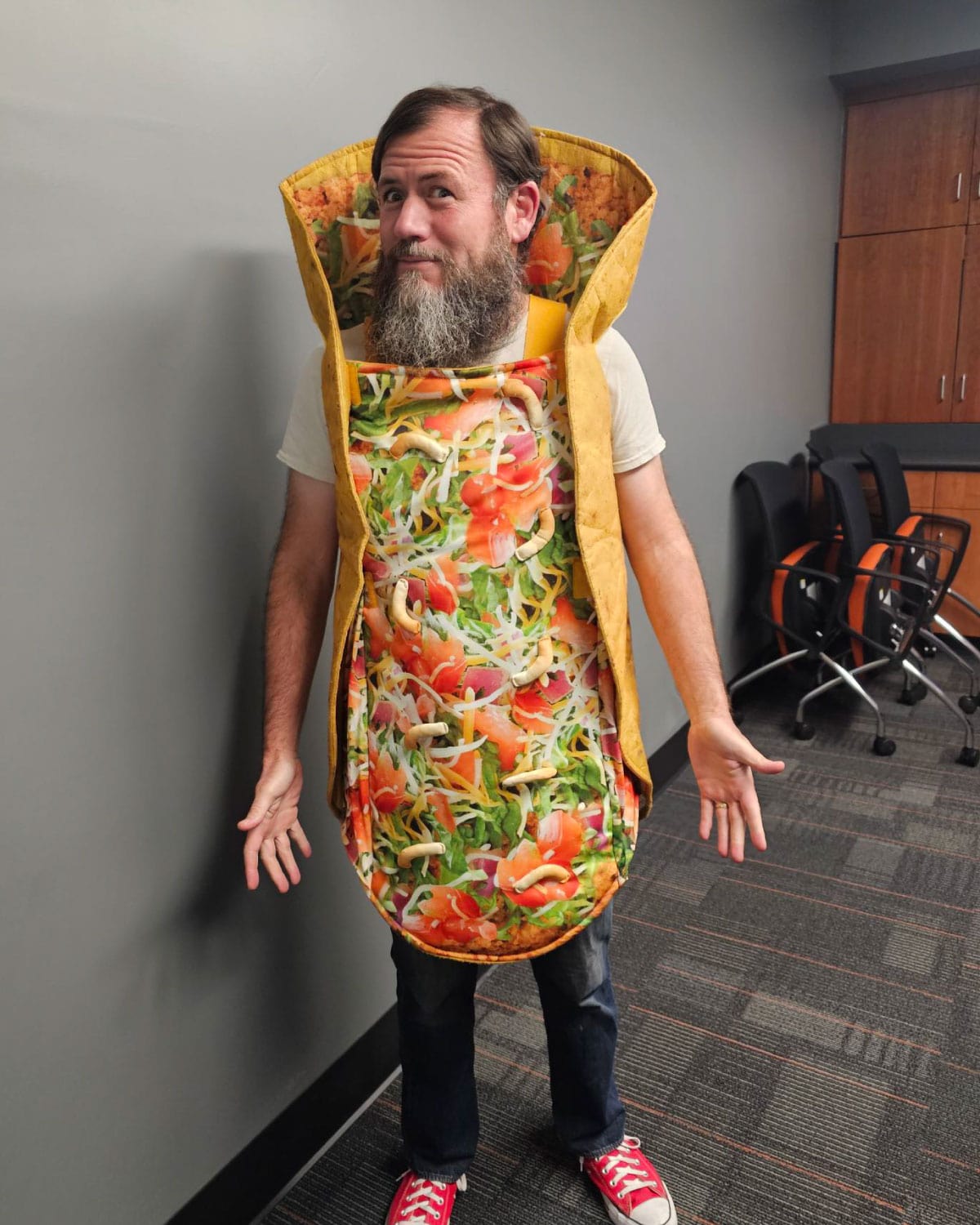 A Teter employee wearing a humorous taco costume, posing playfully indoors.